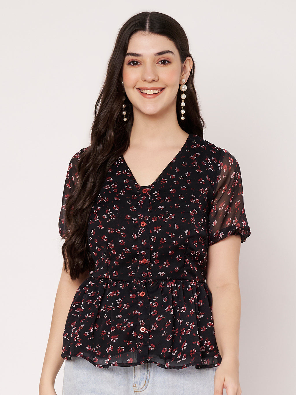 Black floral print peplum top featuring a V-neckline and button-down front.