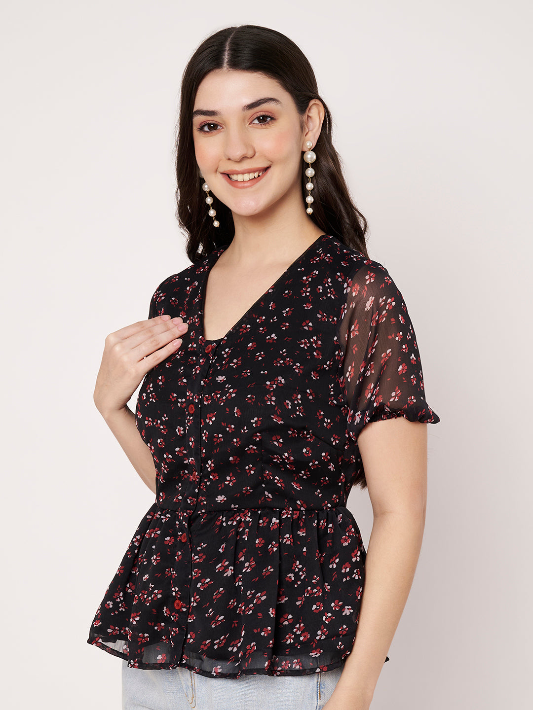 Casual black floral peplum tunic top featuring sheer flutter sleeves.