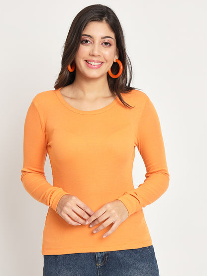 Casual orange ribbed top styled with jeans